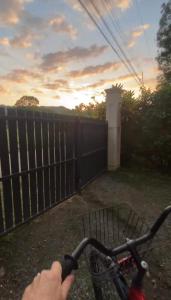 a person riding a bike in front of a fence at Casa Selva in Cabuya