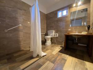 y baño con ducha y lavamanos. en Grateus Luxury Apart & Spa en Villa General Belgrano