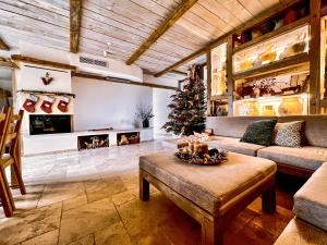 a living room with a christmas tree and a couch at Kaska Ház in Tihany