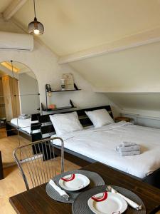 a bedroom with a bed and a table with plates on it at Room in Oss in Oss