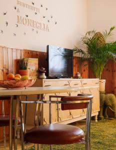stół z telewizorem i stół z miską owoców w obiekcie Moneglia Beach Downtown w mieście Moneglia