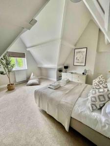 a bedroom with a large bed in a attic at The Old Vicarage - sleeps 20 in Kettleburgh