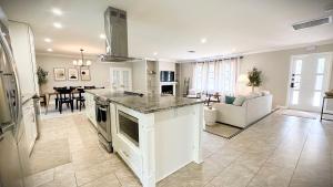 a large kitchen and living room with a counter top at Luxury Jupiter Farm Getaway Pool, BBQ, Game Shed in Jupiter +31 photos