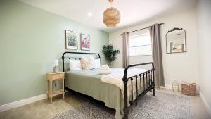 a bedroom with a bed and a mirror at Luxury Jupiter Farm Getaway Pool, BBQ, Game Shed in Jupiter