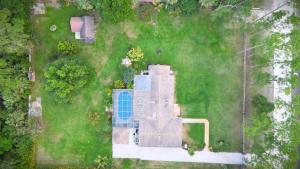 an overhead view of a house with a pool in the grass at Luxury Jupiter Farm Getaway Pool, BBQ, Game Shed in Jupiter