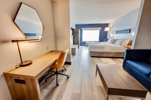 a hotel room with a desk and a bed at Holiday Inn Express Hotel & Suites Ohio State University- OSU Medical Center, an IHG Hotel in Columbus