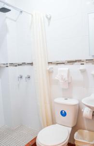 a bathroom with a toilet and a shower at Luna de Plata in Quetzaltenango