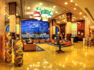 a lobby of a hotel with couches and a large window at Porto Matrouh Beach Resort in Marsa Matruh
