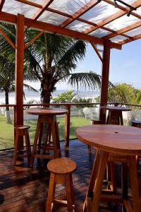 a patio with tables and chairs and a palm tree at Casa Cancun Hotel Boutique & Eventos in Penha