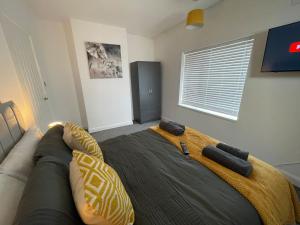 a bedroom with a bed with a blanket on it at Redcar Retreat in Redcar