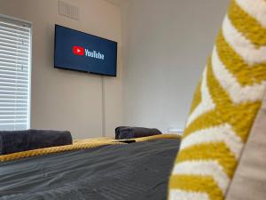 a room with a bed and a tv on a wall at Redcar Retreat in Redcar