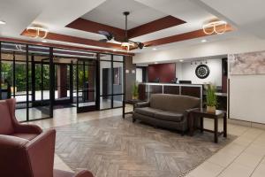 an office lobby with couches and a bar at Red Roof Inn & Suites Savannah Airport in Savannah