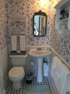 a bathroom with a toilet and a sink at Victorian by the Sea in Lincolnville