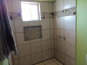 a bathroom with a shower with a window at Departamento #7 in San Felipe