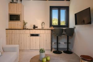 a living room with a couch and a kitchen at Berthina House in Dhrakopouláta +9 photos