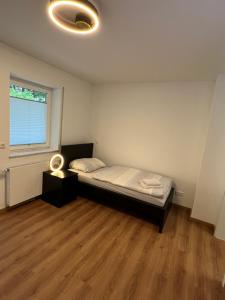 um pequeno quarto com uma cama e uma janela em KoldeApart nahe Siemens Campus em Erlangen