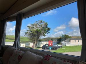 a window with a view of a gas station at NB166 - Porth Bay Hideaway in Porth