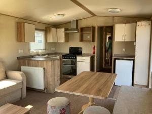 a small kitchen with a wooden table in it at NB166 - Porth Bay Hideaway in Porth