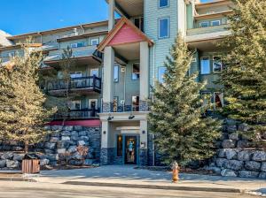 a building with a fire hydrant in front of it at Rocky Mountain Getaway with Outdoor Heated Pool, 3 Hot Tubs, Gym, BBQ, Garage & 24 hour Reception near Banff in Canmore
