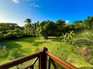 a view of a garden from a wooden deck at Kaz Manga Rose in Deshaies