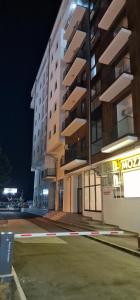 a large building at night with a parking lot at cocoluxapartmanl73 in Trnava