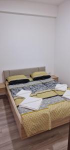 a bed with pillows on it in a room at cocoluxapartmanl73 in Trnava