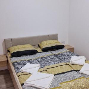 a large bed with white towels on top of it at cocoluxapartmanl73 in Trnava