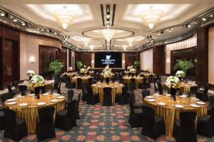 a ballroom with tables and chairs in a room with chandeliers at JW Marriott Shanghai at Tomorrow Square in Shanghai
