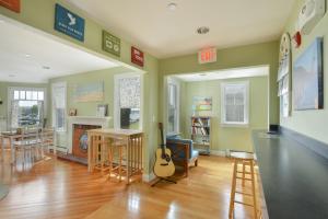 a living room with a guitar and a table at HI Hyannis Hostel in Hyannis