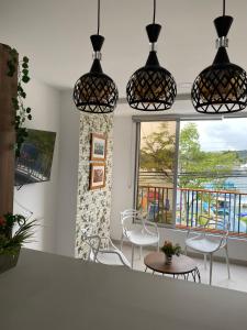 a room with chairs and a table and a window at Apartamentos Avenida del malecón, frente al lago. Guatape in Guatapé +78 photos