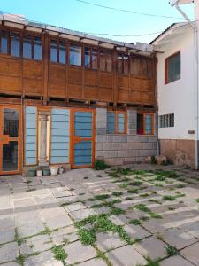a building with blue and orange doors on it at Ukumari Hostel in Cusco