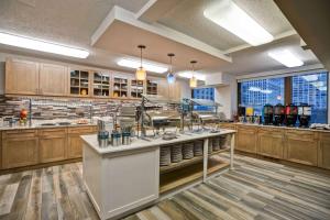 a large kitchen with wooden cabinets and a counter top at Homewood Suites by Hilton Chicago Downtown in Chicago