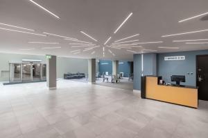 an empty office lobby with a large ceiling at Hilton London Gatwick Airport in Horley