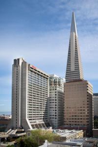 a large building with a tall tower in a city at Hilton San Francisco Financial District in San Francisco