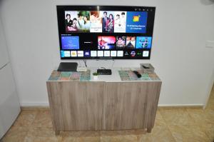 a flat screen tv sitting on top of a desk at Serenity Garden in Maspalomas