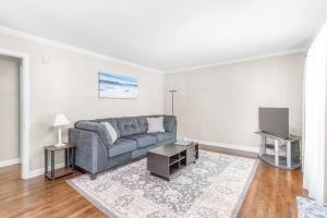 a living room with a couch and a tv at Spotless 4BR near CLT Uptown, Fast Wi-Fi in Charlotte