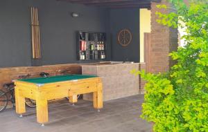 a ping pong table in front of a bar at Casa na Praia de Bertioga in Bertioga