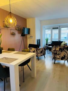 a living room with a table and chairs at Appartement Thea in Westende-Bad