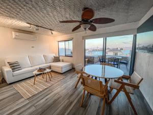a living room with a couch and a table at Fabulous Condo with Oceanview, Beach access and pool! Behind the Marina in San Carlos