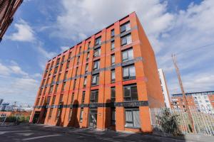 a red brick building on the corner of a street at Contemporary 2 bedroom Apartment - Birmingham City Centre - Digbeth Bullring in Birmingham
