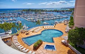 a large swimming pool next to a marina with boats at Prince Waikiki in Honolulu