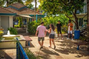 a man and a woman walking through a yard at YHA Cairns Central in Cairns +30 photos