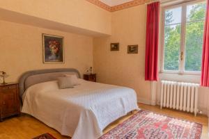 a bedroom with a bed and a window with red curtains at Villa Volpe Como in Lanzo dʼIntelvi