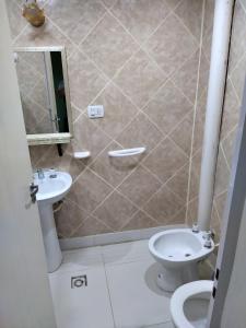 a bathroom with a toilet and a sink at DAP 2 in Río Gallegos