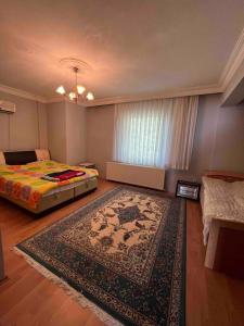 a bedroom with a bed and a rug on the floor at VILLA in Tekirdag- Istanbul in Tekirdag