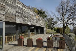 an external view of a building with a wooden deck at Gerês - Leiras do Tempo - Cottages in Brufe