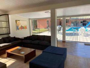 a living room with a couch and a coffee table at CHÁCARA C/ PISCINA, SALÃO DE FESTA E CHURRASQUEIRA in Campo Largo