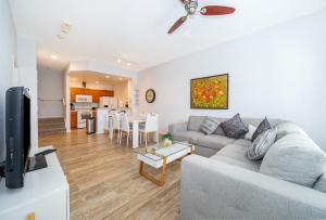 a living room with a couch and a table at Enchanted Townhome near Disney Parks 3Br in Kissimmee