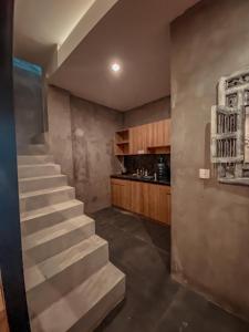 uma escada numa cozinha com uma escadaria de estesteryasteryasteryasteryasteryasteryastery em Reddoorz Holistic Pod Hostel Kuta em Kuta