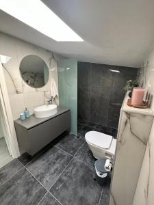 a bathroom with a sink and a toilet and a mirror at Villa Sunset Yerakini in Poligiros +47 photos